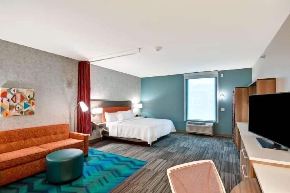 Hypo-allergenic bedding, desk, laptop workspace, blackout drapes