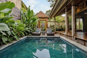 A pool area with two lounge chairs and a wooden pergola. - The Ulon Ubud Villa (Ubud)