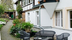 A traditional building with a steeply pitched roof, dormer windows, and a small tower-like structure. - Apartment 'Loschwitz' with Wi-Fi (Dresden)