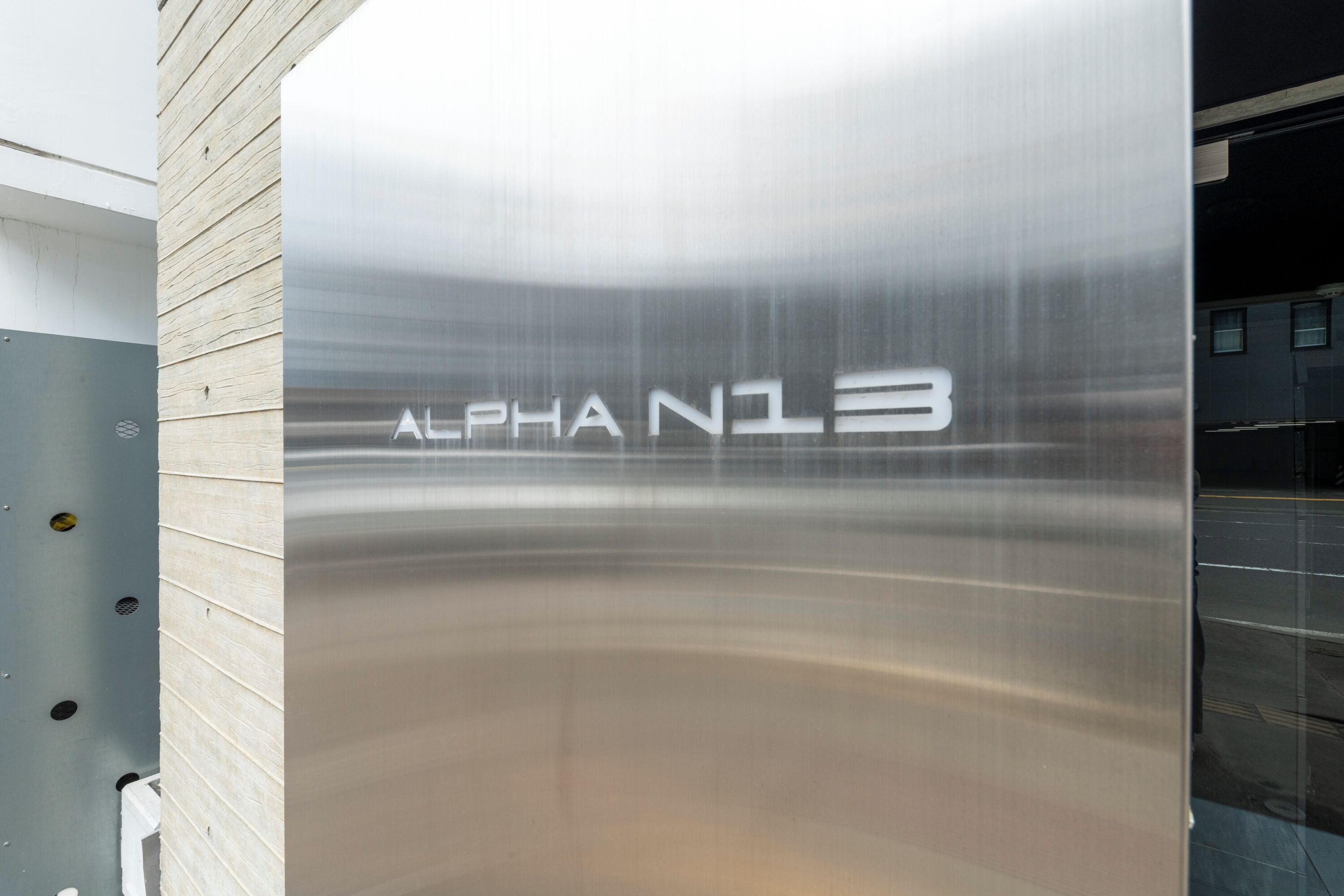 A metallic elevator with the inscription "ALPHA N13".
