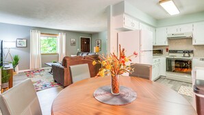 A modern kitchen with white cabinets, a stainless steel oven, and a built-in microwave. - Hot Tub & Fire Pit: Holiday Island Getaway! (Holiday Island)