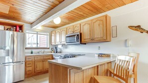 A kitchen with wooden cabinets, stainless steel appliances, and a large island. - Fraser Mountain Retreat w/ Resort Amenities! (Fraser)