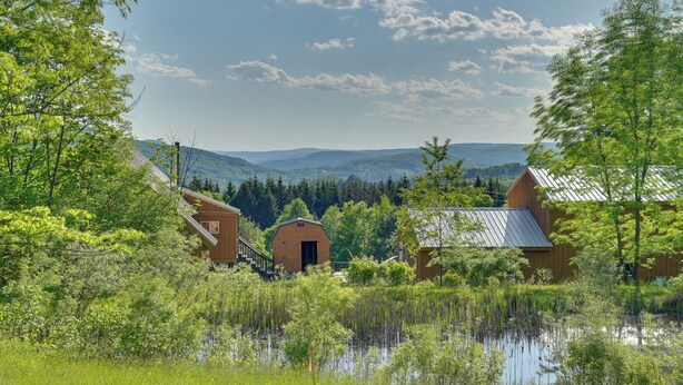 A rural landscape with barns and a pond, surrounded by trees and hills. - Hike, Fish & Unwind! Catskills Studio w/ Mtn Views (Stamford)