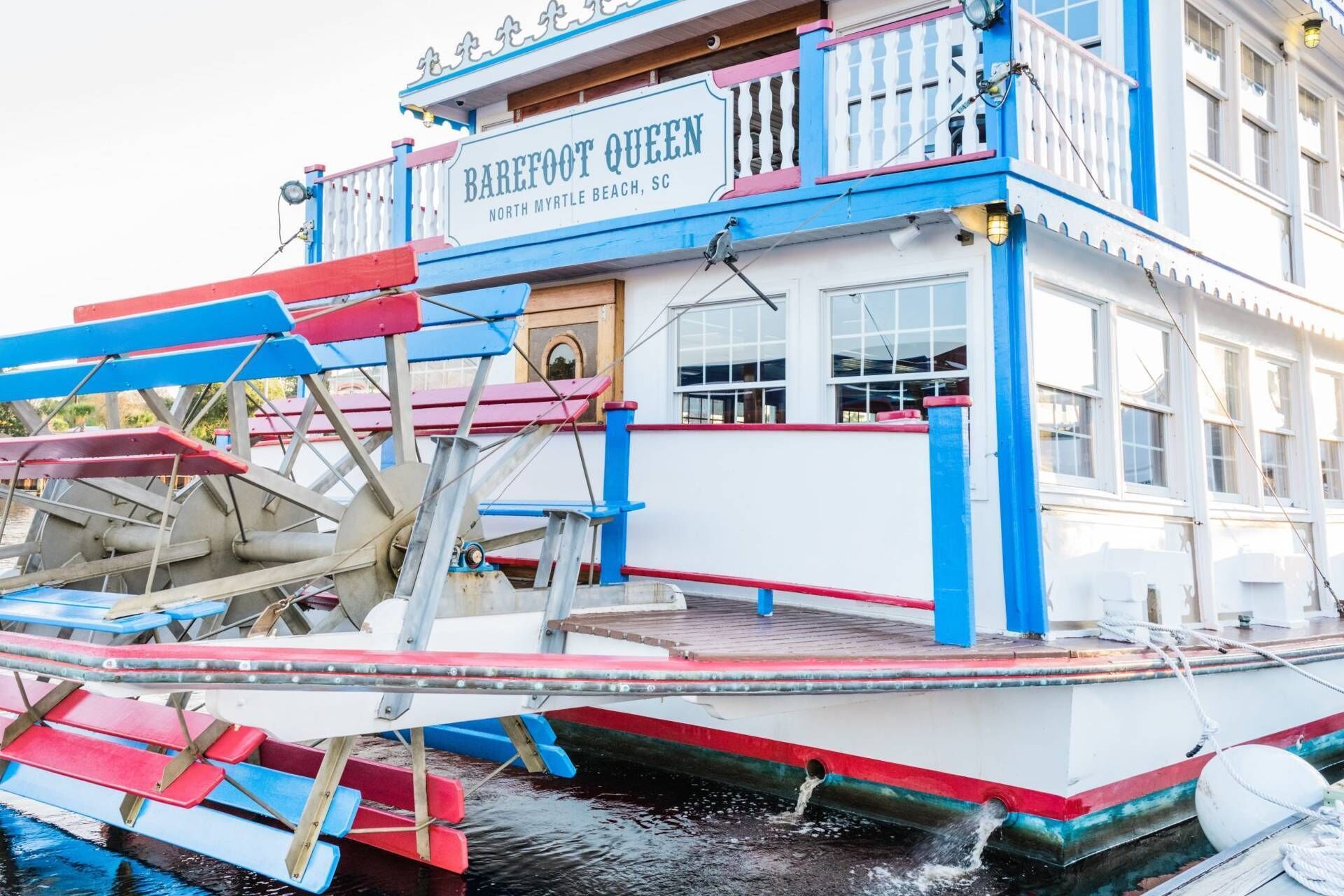 A boat with a sign reading 'Barefoot Queen North Myrtle Beach, SC.'