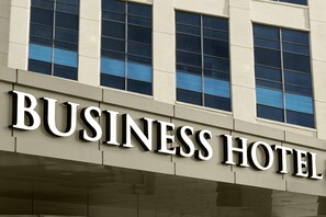 A building with the sign "BUSINESS HOTEL" indicating it is a commercial hotel.