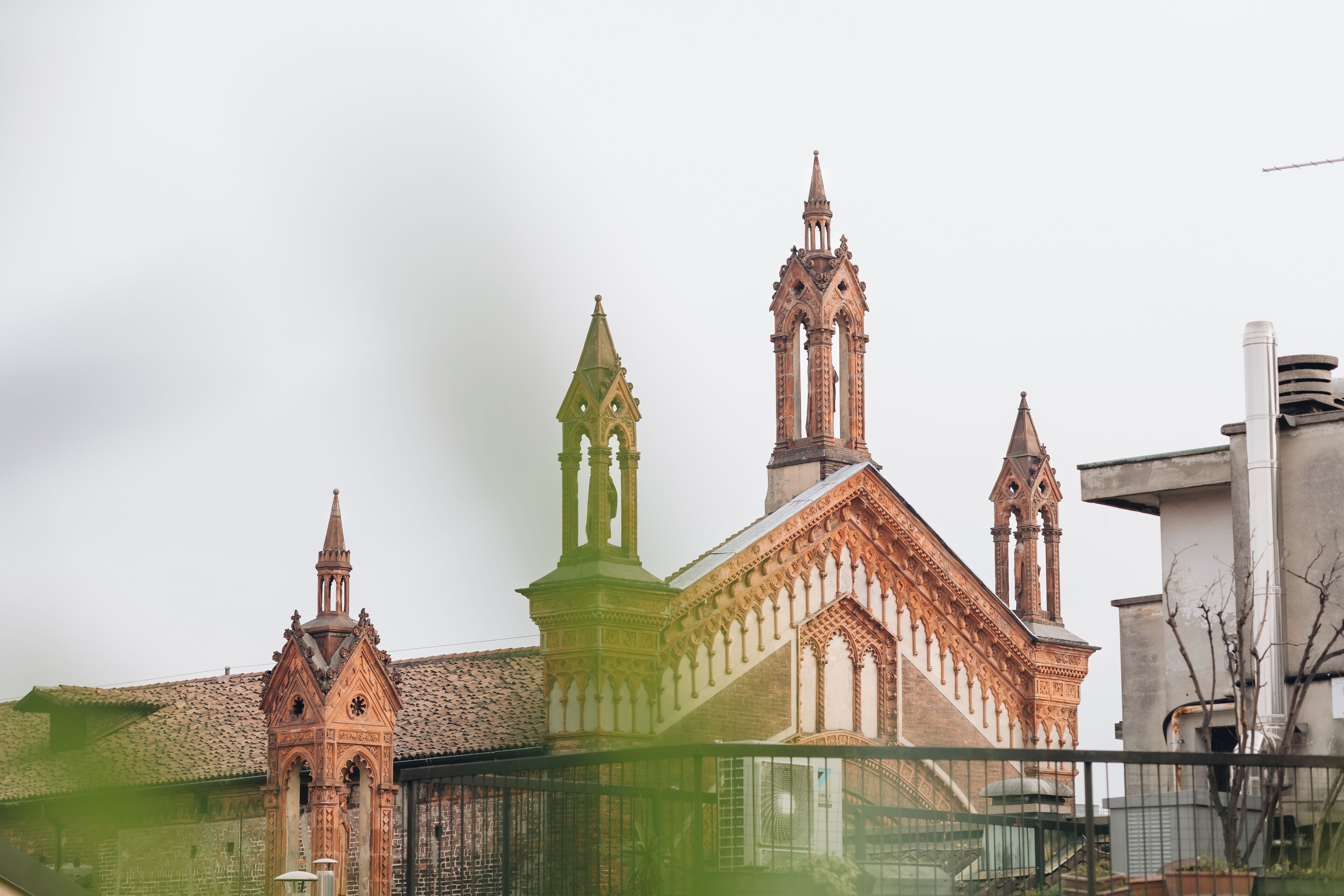 A historic building with intricate architecture, including multiple towers and a prominent clock tower.