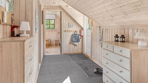 A wooden interior with a desk, drawers, a lamp, a door, and a window. - "Niesina" - 600m to the fjord by Interhome (Højslev)