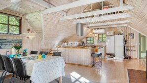 A cozy wooden cabin with a dining area, kitchen, and a loft bedroom. - "Niesina" - 600m to the fjord by Interhome (Højslev)