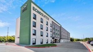 A modern hotel building with the name 'Echo Suites' on the facade.