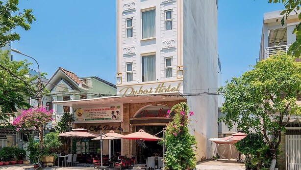 A tall hotel with a prominent sign reading "Dubai Hotel." - Dubai Hotel (Da Nang)