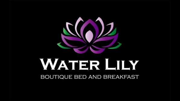 A logo with a lotus flower and the text "Water Lily Boutique Bed and Breakfast".