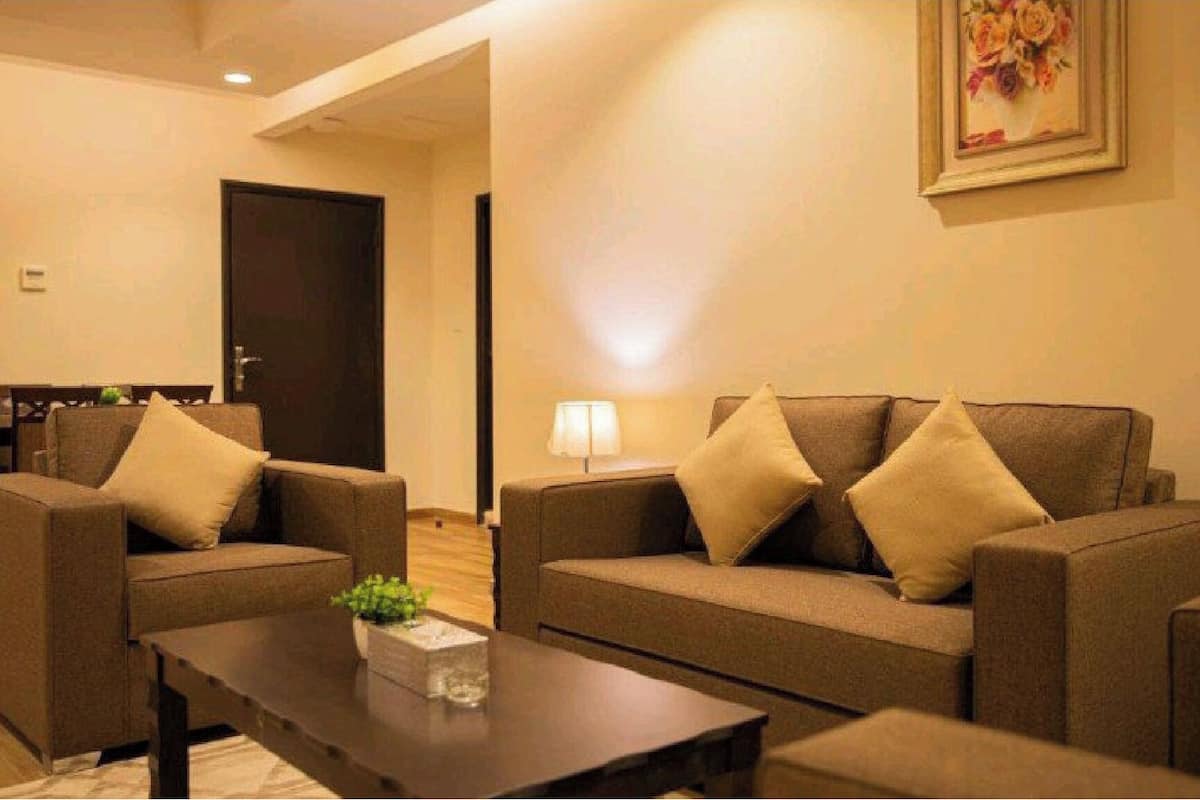 A living room with two sofas, a coffee table, and a lamp.