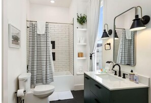 Shower, hair dryer, towels, toilet paper
