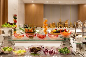 A buffet with various food items and decorative elements. - S Lux Apartment Virgo Nha Trang (Nha Trang)