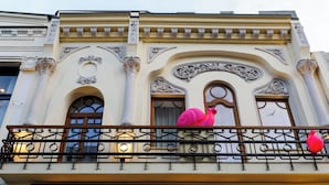 A building facade with ornate architectural details, including columns and decorative moldings. - OLD TOWN SNAIL Design Apartments (Bucharest)