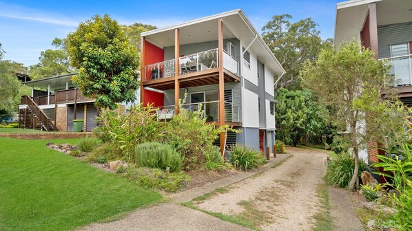 A two-story residential building with a balcony and a covered porch. - Allora 1 by Discover Stradbroke (Point Lookout)