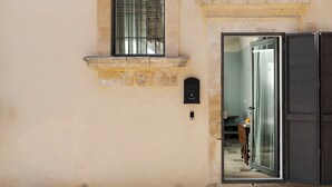 A building with a window, a door, and a small window above the door.