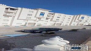 A modern building with multiple balconies and a parking area. - Appartement a Louer au Nord du Maroc Fnideq (Fnideq)
