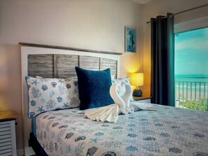 Relax in comfort with a large bed, flanked by two pillows, and a neatly folded towel.