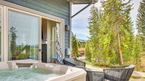 A hot tub area with chairs, a glass door, and a view of trees and a building. - Walk to Dtwn: Fraser Retreat w/ Hot Tub & Views! (Fraser)