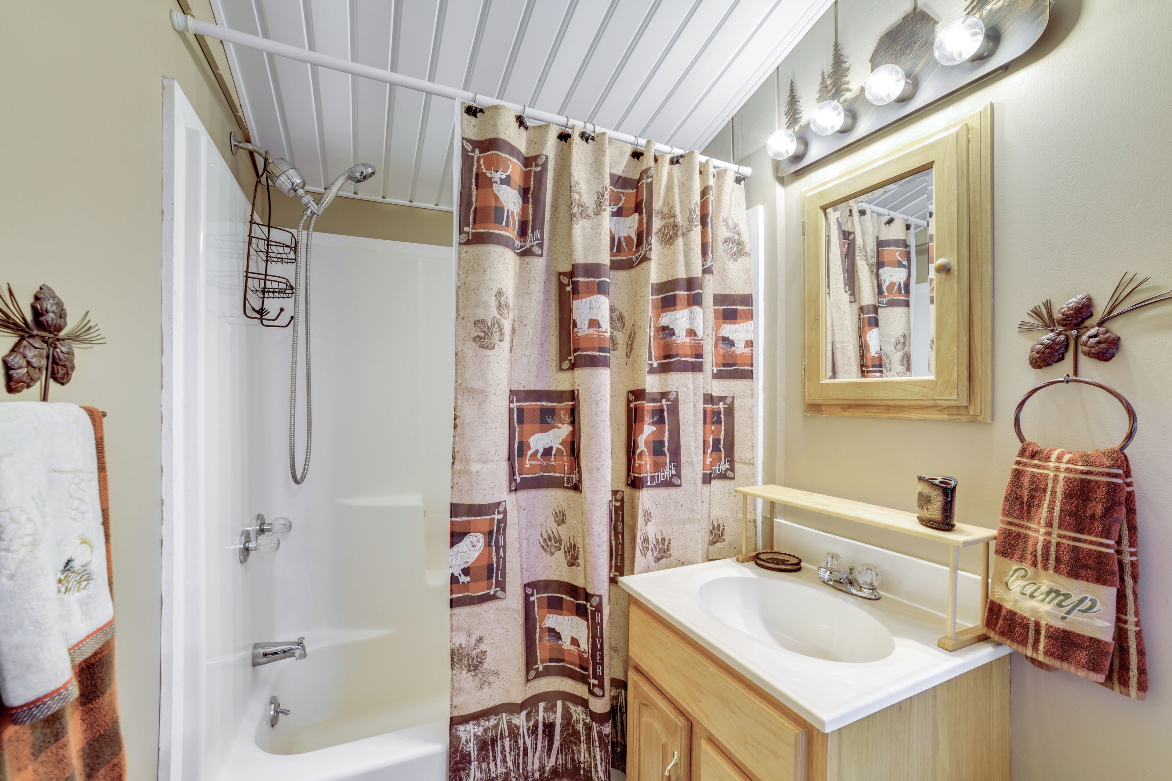 A bathroom with a shower, a bathtub, a sink, and a mirror.