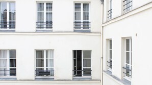 A multi-story building with balconies and windows.