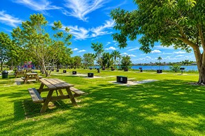 A park with picnic tables, numbered benches, and a lake view. - House w/ Pool, Hot Tub & Backyard (Cape Coral)