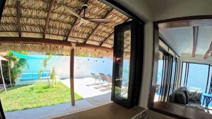 A kitchen with a view of a pool and lounge area. - Casa Bugambilia-Santa Cruz Pool & walk to Beach! (Avienda)