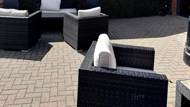 An outdoor seating area with wicker furniture and a wall with the text "the terrace". - Modern & Blissful Beach Holiday Park Home in Essex (Harwich)