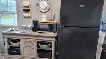 Fridge, microwave, coffee/tea maker, cookware/dishes/utensils