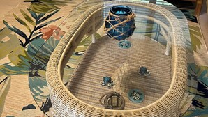 A living room with two armchairs, a glass-top coffee table, and a small side table. -  Sunsets on the Sands in the Villages! Golf Front  3/2 (The Villages)