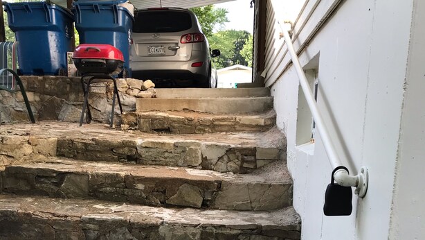 A set of stone steps leading to a garage with a car parked inside. - Studio, sleeps 4, patio, short drive to Ski Resort, Six Flags & concert venues (Ballwin)