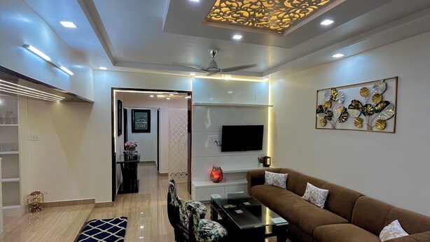A modern living room with a brown sofa set, a glass coffee table, and a patterned rug. - Patio Paradise, Pitampura
Cozy and peaceful 3BHK Condo (New delhi)