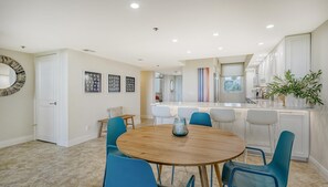 Enjoy meals in this stylish dining area with a round table and comfortable seating for all.