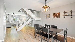 A modern interior with a staircase, dining area, and motivational wall art. - Ideal Old Town Scottsdale Location! Perfect for Families. Camelback Mt. View! (Scottsdale)