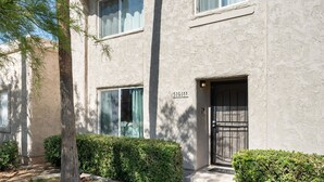 A two-story building with a textured facade, a number '51601' on the wall, and a black gate at the entrance. - Ideal Old Town Scottsdale Location! Perfect for Families. Camelback Mt. View! (Scottsdale)