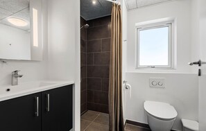 A modern bathroom with a shower, toilet, and sink. - Lovely home in Rømø with sauna (Rømø)