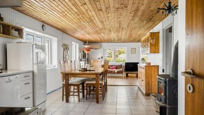 A modern kitchen with a wooden ceiling, white cabinetry, and a built-in stove. - Nice home in Harboøre with WiFi (Harboøre)