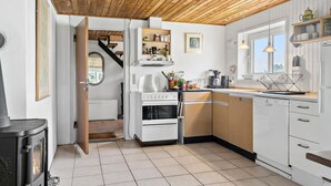 A modern kitchen with white cabinetry, a wooden ceiling, and a view to the outside. - Nice home in Harboøre with WiFi (Harboøre)