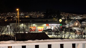 A Eurospaar bank building at night with a snow-covered roof and a view of a cityscape in the background.
