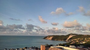 A coastal town with a view of the sea and hills. - Edifício Flat Euro (Natal)