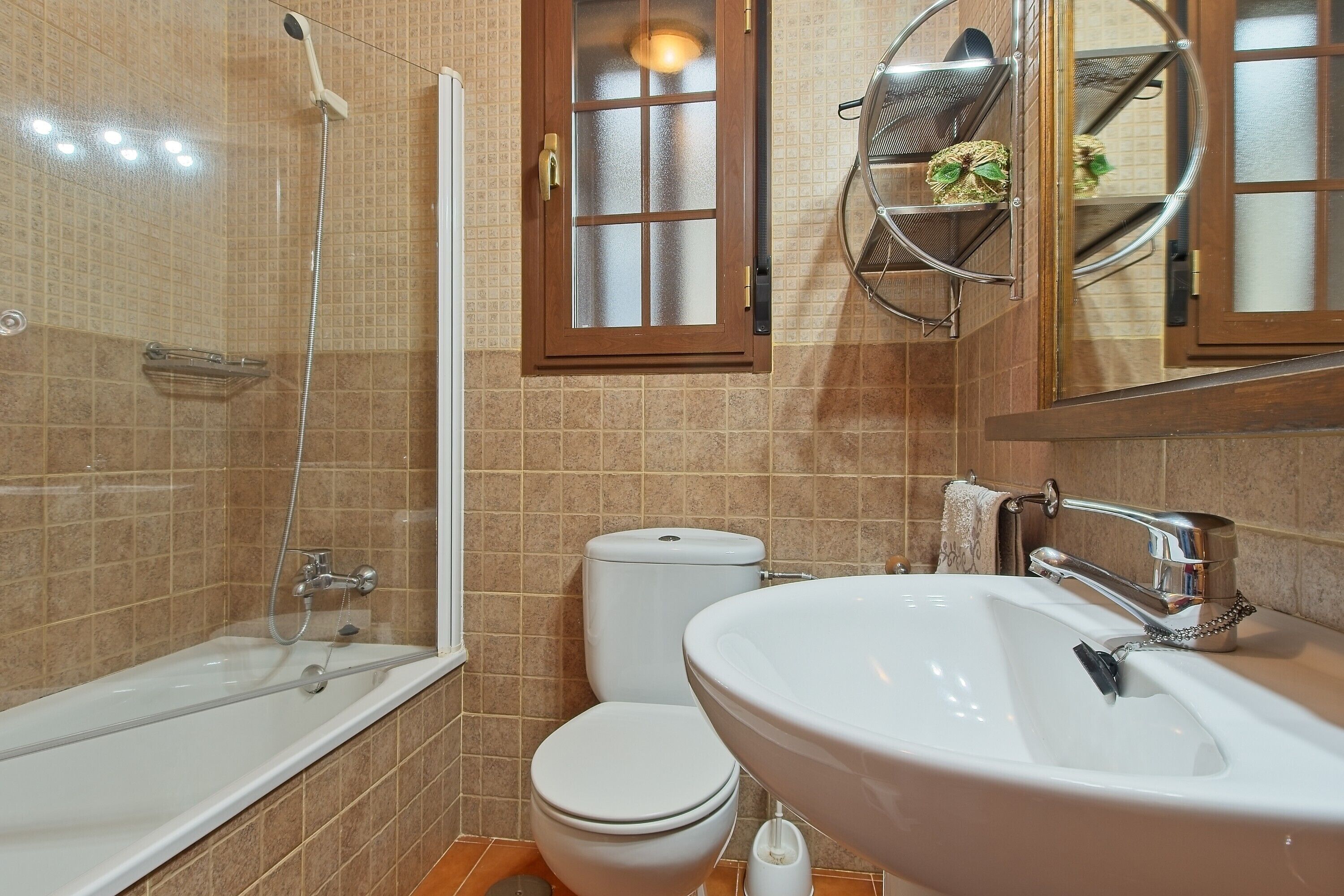 A bathroom with a bathtub, toilet, and sink.