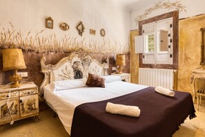 A classic room with a large bed, ornate headboard, wall-mounted mirrors, and a window with shutters. - Country House 'Señores Y Tía Juana' with Mountain View, Private Pool and Wi-Fi (Monovar)