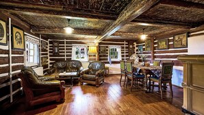 A log cabin interior with wooden floors, leather furniture, and rustic decor. - Jizerka by Interhome (Tanvald)