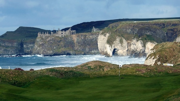 A coastal golf course with a castle in the background. - Central Portrush Penthouse Retreat (Portrush)