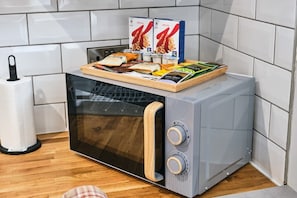 Enjoy a convenient kitchen setup with a microwave oven and ample storage for your essentials.