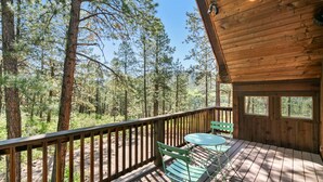 A wooden deck with a table and chairs overlooking a forest. - A/C, Views, Newly Renovated, Peaceful Retreat! (Durango)