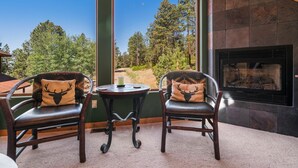 A room with two leather chairs with deer head cushions, a small round table, and a stone fireplace. - A/C, Views, Newly Renovated, Peaceful Retreat! (Durango)
