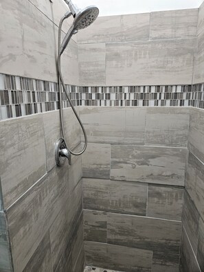Een douche, handdoeken, zeep, shampoo