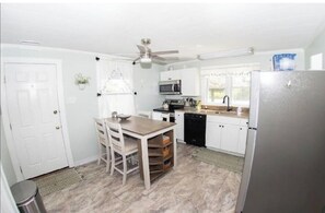 Functional kitchen with modern design, microwave, oven, and dishwasher, perfect for cooking and dining.